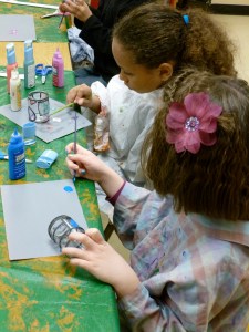 3rd graders paint stained glass candle holders