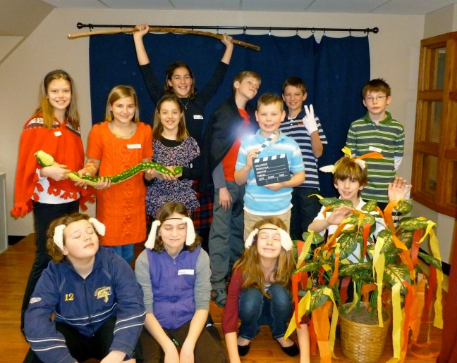 the 5th grade poses on stage at the Drama Workshop