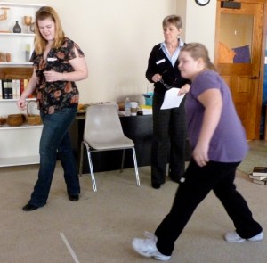 A team member takes a shot at the bowling pins