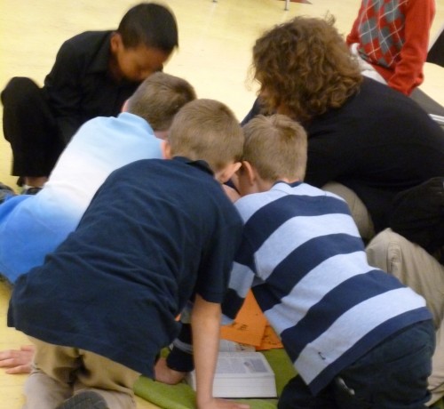 A group of kids works together to determine an answer