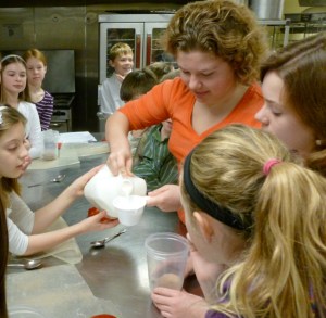 Students make "dirt" pudding out of crushed Oreos