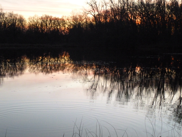 The sun sets over the lake