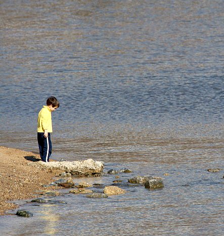 A child contemplates rocks