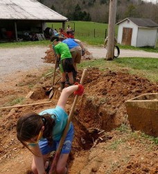 A crew digs a trench for a water line