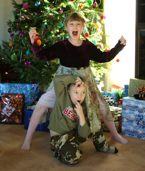 kids acting bizarre in front of the Christmas tree
